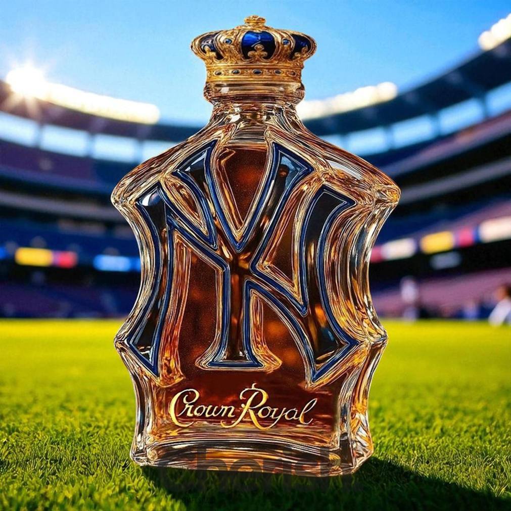 New York Yankees NY-shaped whiskey bottle branded with Crown Royal, featuring a golden crown stopper on a baseball stadium field