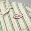 Obsession Movie Cassells Music Shirt Worn by Bear in Curry Barker's Film with green stripes and a chest oval patch logo