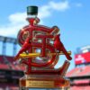 Louis Cardinals 11X World Series Champions Whiskey bottle with a dark green cap, standing in front of a stadium board