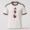 Manchester United 2026 Third Soccer Jersey with off-white floral pattern, maroon centered crest, and black sleeve stripes