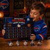 Alt Text: Buffalo Bills Football Halloween 2026 Advent Calendar held by a young fan wearing a blue Bills hoodie