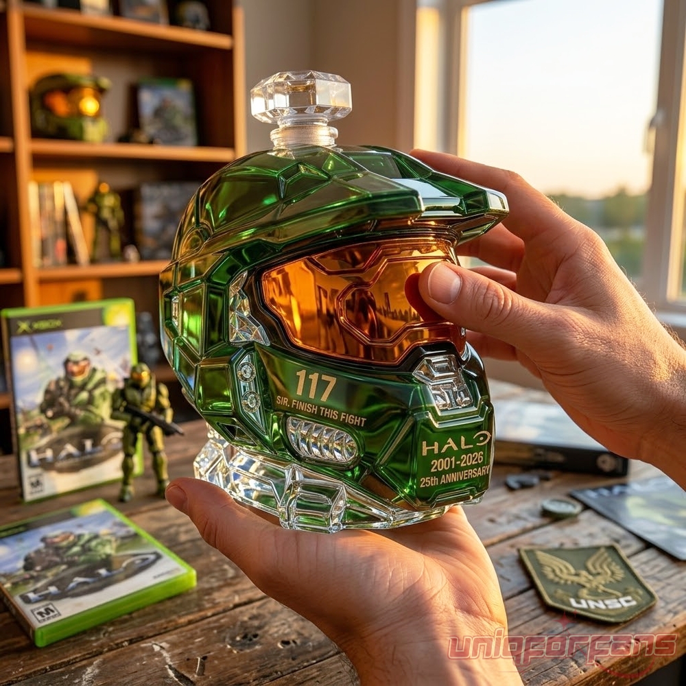 Hands holding a Master Chief helmet-shaped Halo 25th Anniversary whiskey decanter bottle in front of video games
