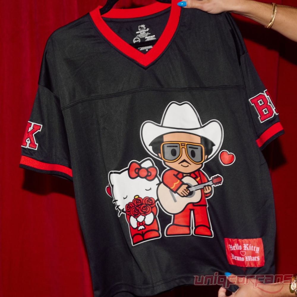 Hello Kitty x Bruno Mars Romantic Tour Black V-Neck Jersey held in hand in front of red backdrop