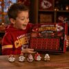 Kansas City Chiefs Football Halloween 2026 Advent Calendar held by an excited boy wearing a red team hoodie