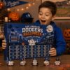Los Angeles Dodgers Baseball Halloween 2026 Advent Calendar held by an excited young fan in a blue Dodgers hoodie