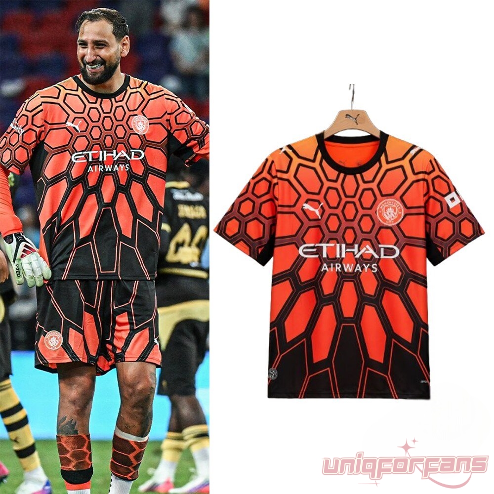 Manchester City 2026 Goalkeeper Hexagon Print Jersey worn on pitch and shown on hanger with orange black honeycomb pattern