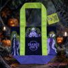 Trader Joe's Disney Villains Trick or Treat Halloween Tote Bag displayed on a dark wooden surface with jack-o'-lanterns in the background