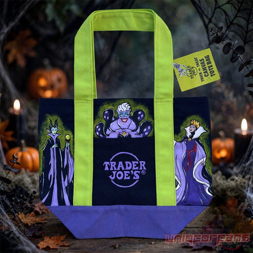 Trader Joe's Disney Villains Trick or Treat Halloween Tote Bag displayed on a dark wooden surface with jack-o'-lanterns in the background